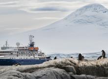 The Sea Spirit glides by a glacier.